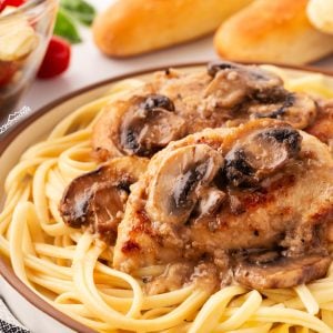 Craving Italian comfort food? Try this delicious Chicken Marsala served over pasta, paired with a tomato basil salad and homemade breadsticks!