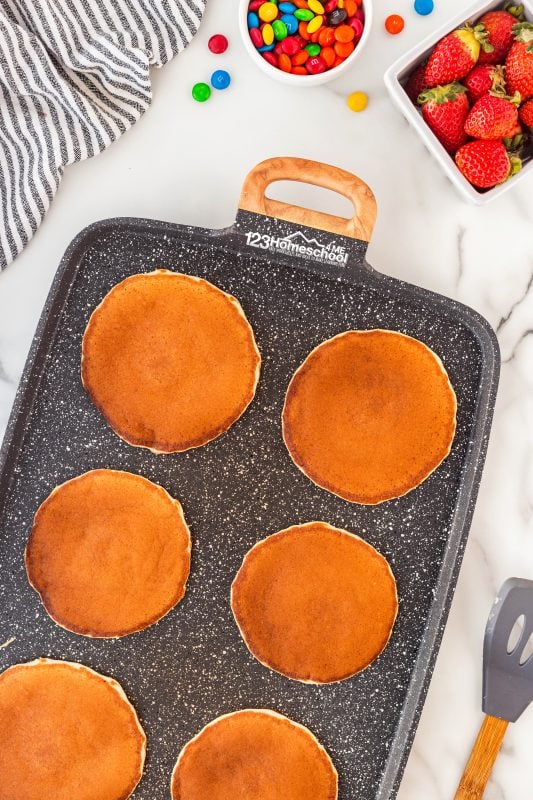 They're ready to flip when bubbles start forming across the surface—this usually takes just around 30 seconds! Use a spatula to carefully turn them over and cook until they’re a lovely golden brown and fully cooked, which should only take about a minute.