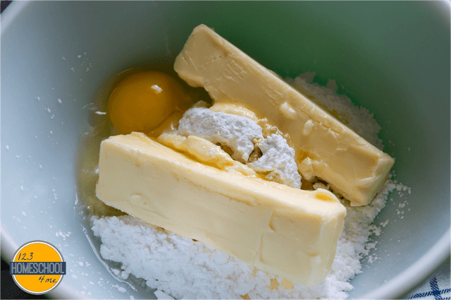 cream together butter, powdered sugar, egg, vanilla and almond extract cream together butter, powdered sugar, egg, vanilla and almond extract
