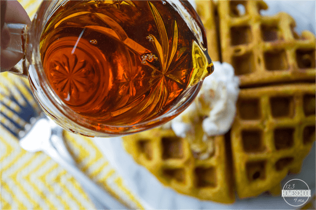 top pumpkin waffles with warmed maple syrup top pumpkin waffles with warmed maple syrup