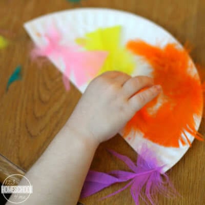 cut a paper plate in half and glue feathers on cut a paper plate in half and glue feathers on
