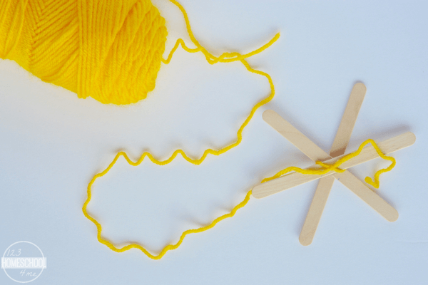 tie yellow yarn around popsicle sticks to make your holiday ornament tie yellow yarn around popsicle sticks to make your holiday ornament