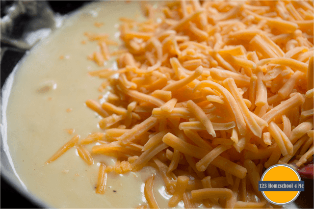 whisk in milk and shredded cheddar cheese whisk in milk and shredded cheddar cheese