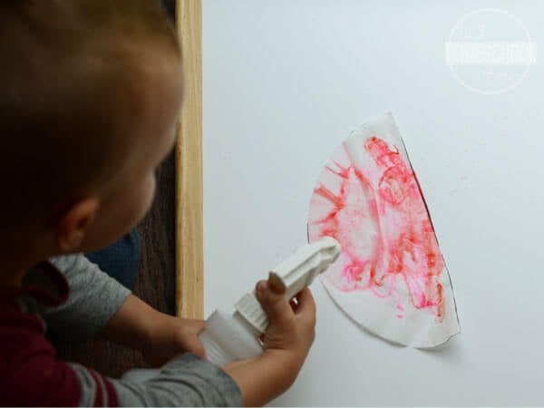 spray marker colored coffee filter with water bottle to create cool bleed effect markers craft for toddlers and preschoolers