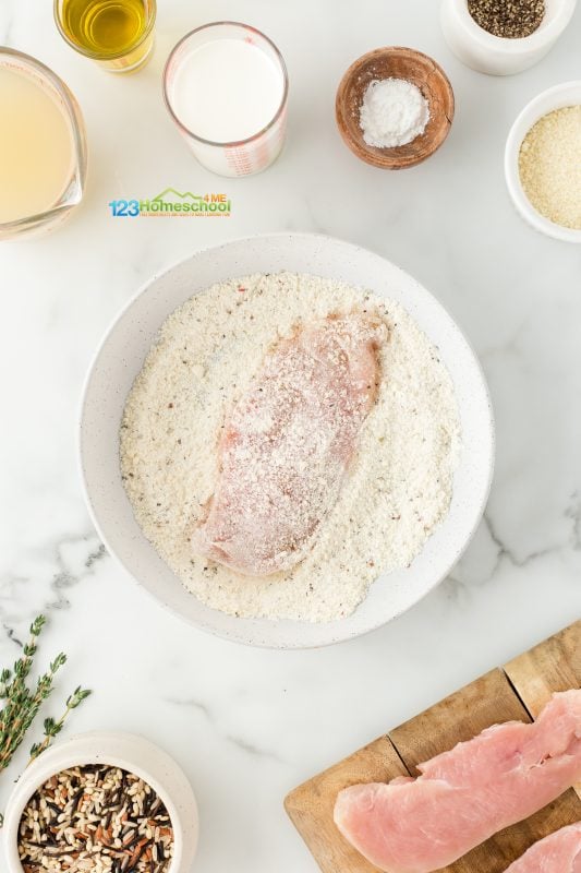 In a shallow dish, combine flour, 3 tablespoons of Parmesan cheese, along with some salt and pepper. Once mixed, coat the chicken thoroughly on both sides in this flavorful flour mixture. coat chicken with flour mixture