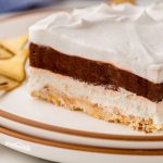 Treat yourself to a slice of heavenly Robert Redford dessert, featuring 4 layers of chocolate pudding, cream cheese, and whipped topping on a buttery nut crust!