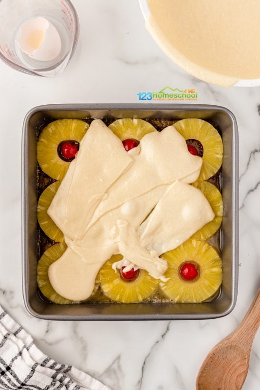 pour pineapple cake over prepared pan and spread evently to cover the pineapple layer