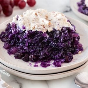 Check out this delicious Grape Delight layered jello salad recipe - bursting with flavors and topped with creamy sweet & tangy topping.
