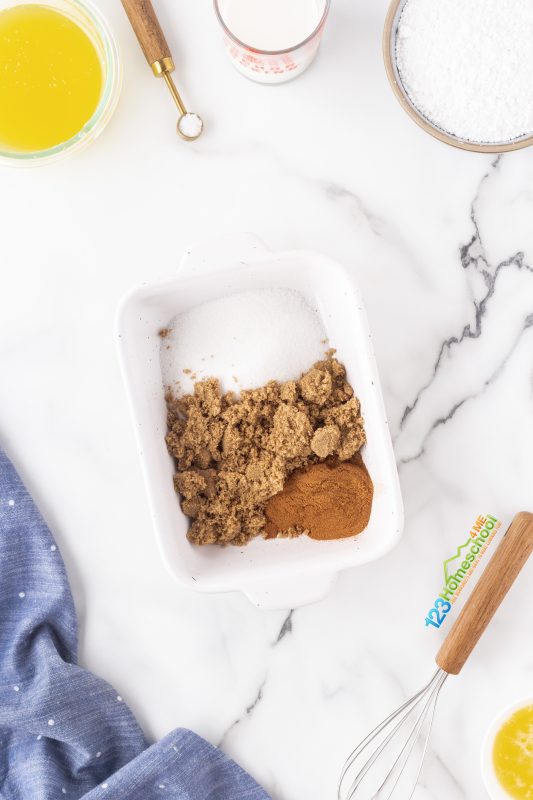 cinnamon sugar coating Time to whip up a delicious topping! Start by combining white sugar, brown sugar, and cinnamon in a small baking dish. In another dish, whisk together melted butter and corn syrup until smooth.