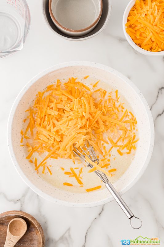 Add in 2 cups of delicious shredded cheddar cheese and mix it all together! cornmeal recipe