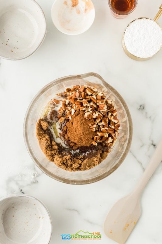 While the dough is rising, take a moment to whip up a delicious filling! In a bowl, combine pumpkin puree, brown sugar, melted butter, pumpkin pie spice, and chopped pecans. Mix well and set it aside.