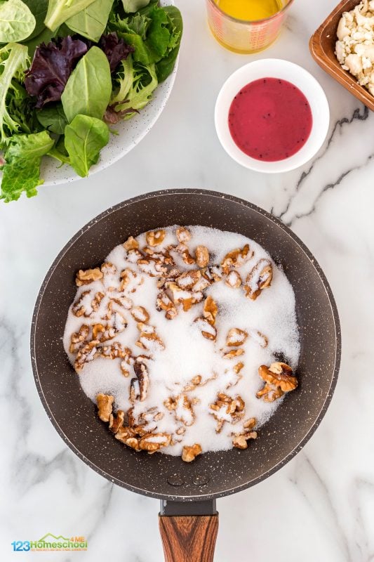 In a skillet over medium heat, toss in some walnuts and sugar. Keep stirring until the sugar melts into a beautiful light brown syrup that perfectly coats the nuts. Once done, spread them out on a cutting board or parchment paper to cool. In a skillet over medium heat, toss in some walnuts and sugar. Keep stirring until the sugar melts into a beautiful light brown syrup that perfectly coats the nuts. Once done, spread them out on a cutting board or parchment paper to cool.