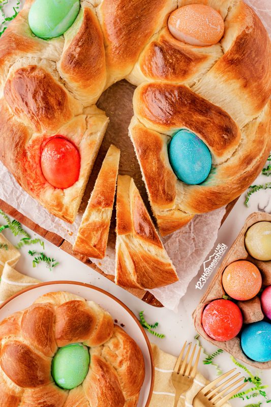 large easter bread wreath with pretty colored eggs baked in easter braided bread