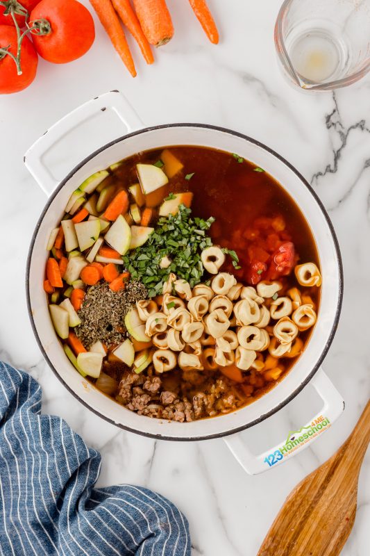add uncooked tortellini and all remaining ingredients Combine the rest of the ingredients in a large crockpot and bring to a boil. Let it cook for 8-10 minutes until the tortellini is tender. Then, reduce the heat and let it simmer on low until you're ready to serve.