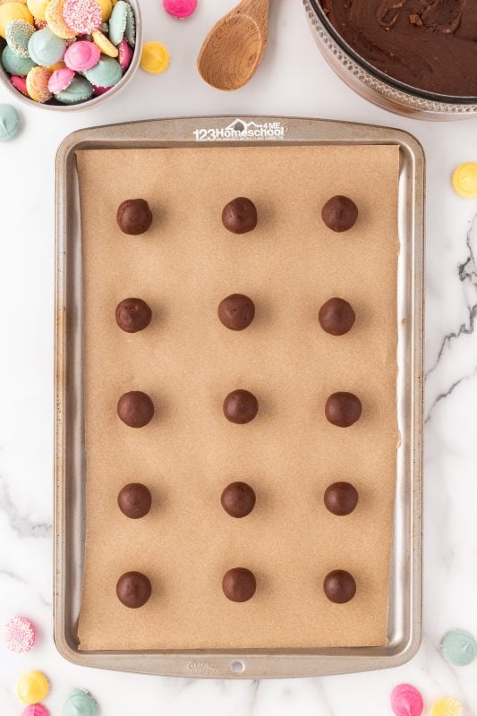 make 1 inch balls of chocolate dough Shape into small 1" balls and place them 2" apart on an ungreased cookie sheet. I like to line the baking sheet with parchment paper to make clean-up a breeze. Bake at 350 F for 8 minutes.