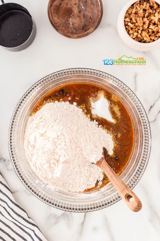 add dry ingredients Then, add in your flour, baking soda, and salt to the carrot mixture. Give it a good mix, and don’t forget to fold in those delicious walnuts!