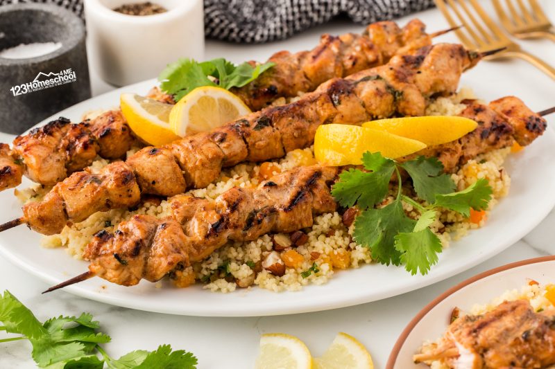 moroccan chicken with couscous Serve up a beautiful dish by spreading fluffy couscous on a lovely platter, then artfully arranging the chicken skewers on top. Finish off with a sprinkle of fresh cilantro and a few vibrant lemon slices for a delightful touch!