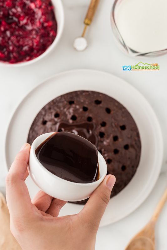 pour chocolate sauce over the cake Now, take that delicious chocolate sauce and gently drizzle it into the holes!
