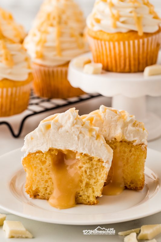 As you take a bite, you'll discover the delicate flavor of almond, complemented by a rich, creamy caramelized white chocolate center that flows out with every nibble. Topped with a light and airy buttercream meringue frosting, these cupcakes are a true treat that will leave you craving more! cupcake white frosting