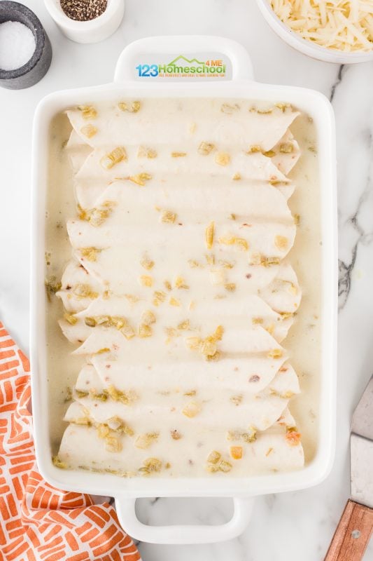 pour sauce over chicken enchiladas Once the Creamy Green Chile Sauce is ready, remove it from the heat and drizzle it generously over the enchiladas in the baking dish.