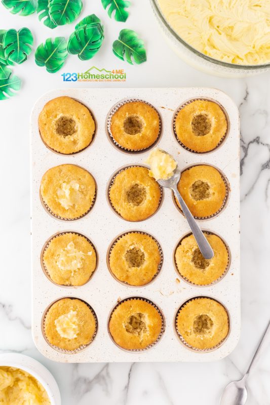 Pineapple Deserts Once your cupcakes have cooled and your delicious filling and frosting are ready, it’s time to transform them into irresistible Pineapple Dole Whip Cupcakes!
To add the pineapple filling, you have two options: either cut a small opening at the top of each cupcake or use a piping bag with a filling tip for a cleaner finish.