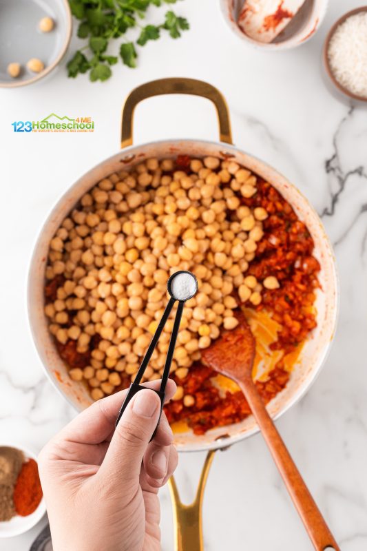 add chickpeas and baking soda Add in those nutritious chickpeas along with a sprinkle of baking soda to the pan with your onion and tomato paste mixture. Give it a good stir to combine all those delicious flavors!