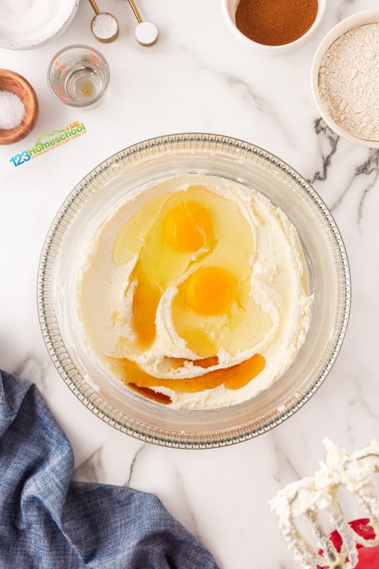 Scrape down the sides, then add your eggs and vanilla extract. Mix it all together for an extra 1-2 minutes until it's nice and creamy!