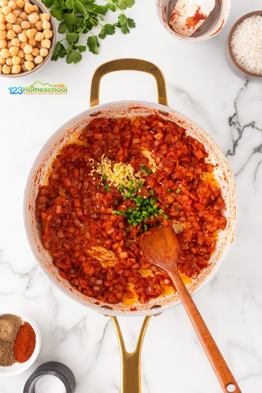add seasoning Add some chili and ginger to the pan, stirring them together until the aroma fills the air and the tomato paste begins to caramelize slightly on the bottom—about 1 minute.