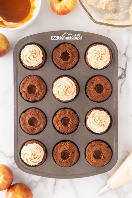 top with homemade caramel frosting Time to top off those delicious apple cinnamon cupcakes with frosting! I love using a piping bag to give them an extra touch of elegance. It not only makes them look gorgeous but also adds a fun swirl of flavor.