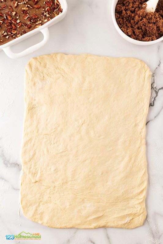 roll out dough into large rectangle First, turn your dough out onto a floured surface and roll it into a 12x16-inch rectangle.